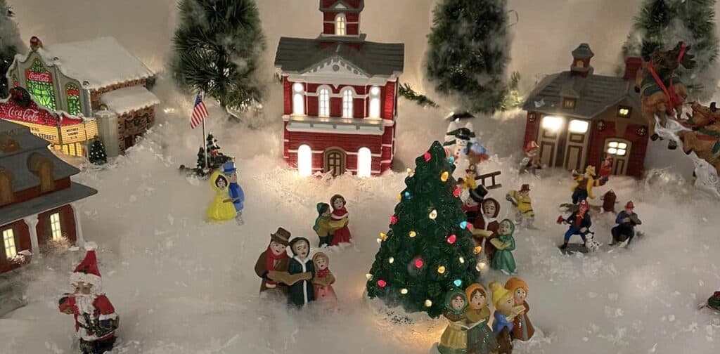 Model village of figurines, trees, and buildings