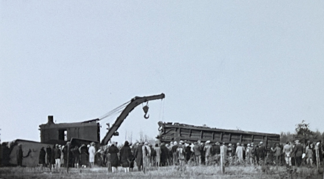 Crew lifts remains of damaged train car.